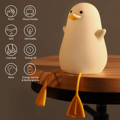 White duck-shaped night light on a wooden surface with feature icons on a dark background