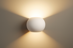 White spherical wall light fixture on a plain wall