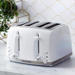 White toaster with a textured finish on a marble surface with a geometric-patterned wall in the background.