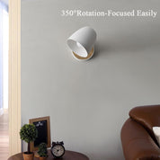 White wall-mounted lamp with 350-degree rotation feature in a room setting.
