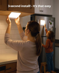 Woman and child installing a light fixture in a kitchen with text '3-second install! It's that easy'.