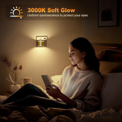 Woman sitting on a bed using a smartphone with a soft glow light fixture above her.