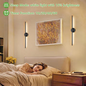 Woman sleeping in a bedroom with wall-mounted lights and a painting on the wall.